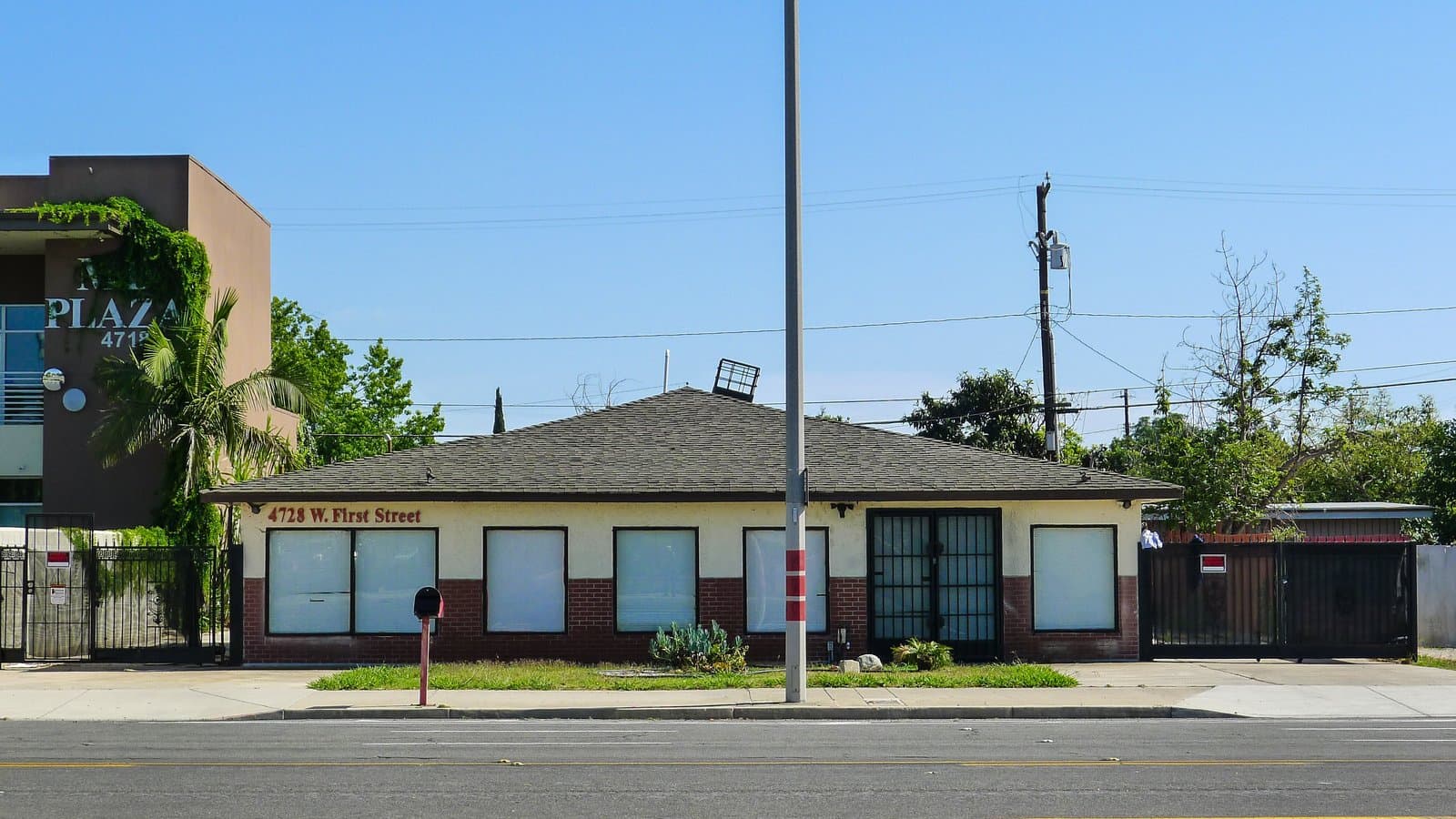 Street-front view of the single-story commercial building at 4728 W. First Street in Santa Ana under a clear blue sky